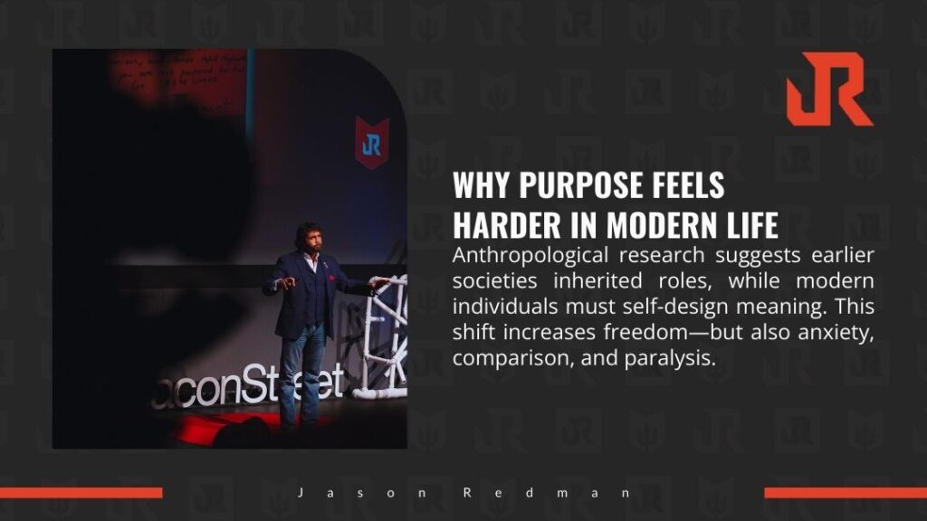 Speaker Jason Redman on stage at a conference, gesturing during talk. Text overlay: "WHY PURPOSE FEELS HARDER IN MODERN LIFE" explaining anthropological shift from inherited roles to self-designed meaning, increasing freedom but also anxiety.