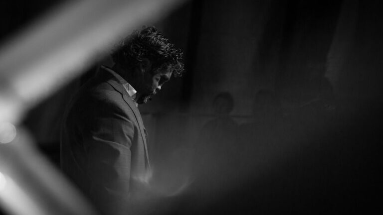 Man in contemplative pose with dramatic lighting; guide about how to find your purpose in life for the lost and confused.