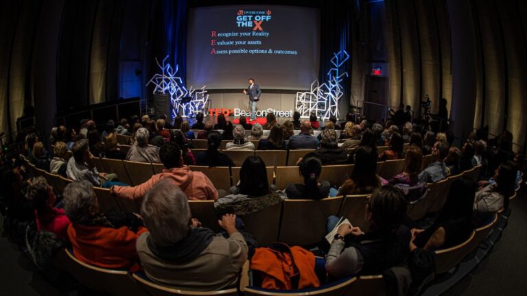 Jason Redman presenting at TEDx event to large audience with decision framework slide, illustrating public speaking techniques and strategies that build confidence and credibility.