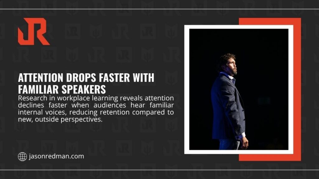 Speaker being introduced on modern conference stage — attention drops faster with familiar speakers as internal voices reduce retention vs outside experts.